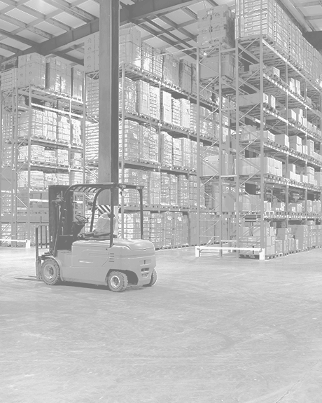 Forklift surrounded by high shelves filled with boxes in warehouse