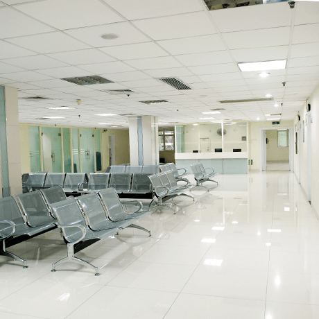 Waiting room inside hospital with white tile floors